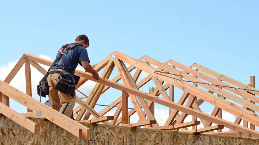 Carpenter Installing Roof Trusses
