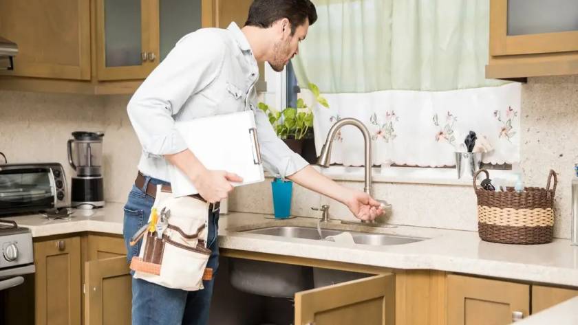 a worker doing temporary sink for kitchen remodel