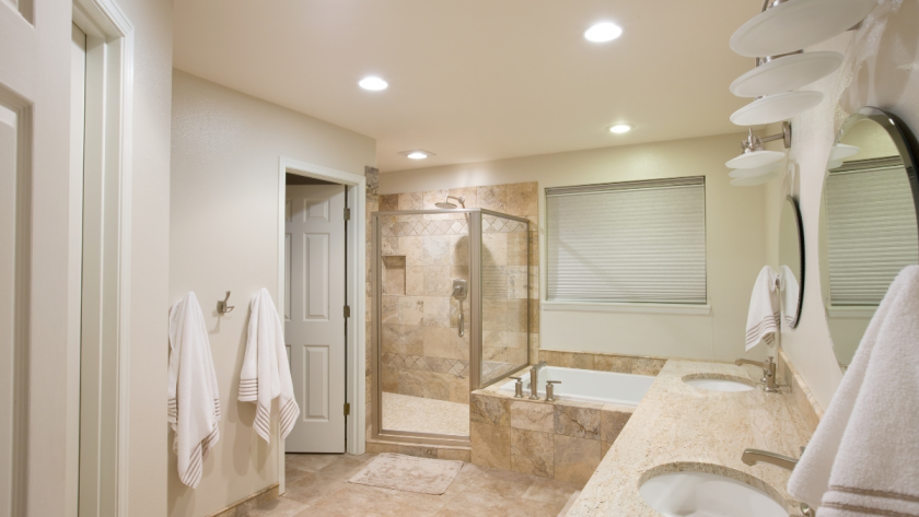 A clean, beautifully remodeled bathroom in beige tones with modern fixtures