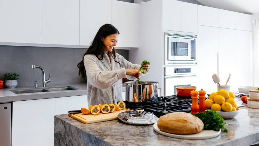 A woman cooking on a newly remodeled kitchen