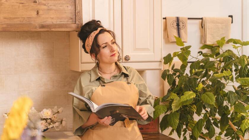 A woman reading in the kitchen