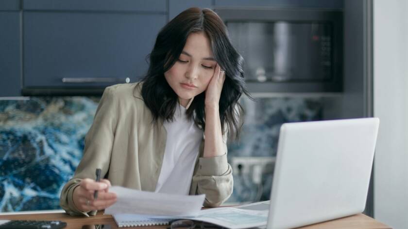 A woman studying in a newly remodeled kitchen